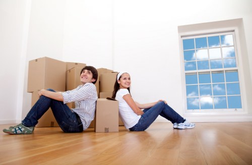 Professional movers handling furniture and boxes during a house move