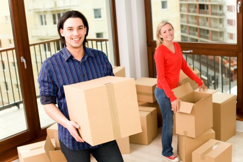Commercial movers preparing office equipment for transport